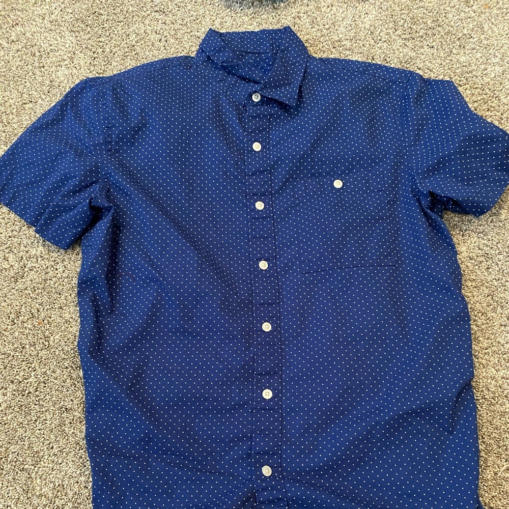Blue button up shirt with white dots